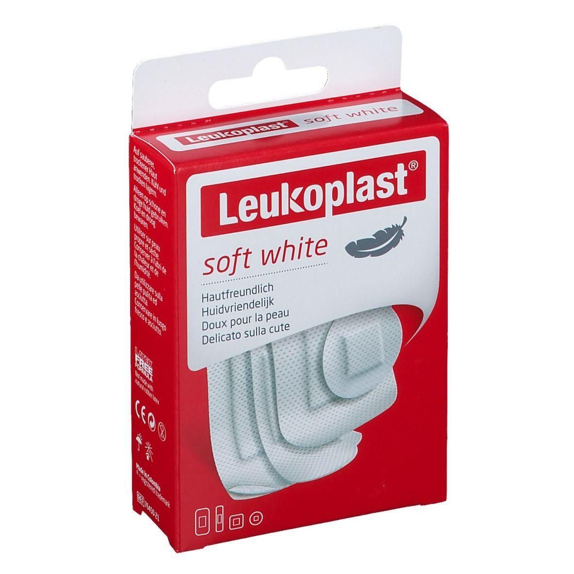 Boîte rouge Leukoplast. Pansements blancs visibles. Inscription: soft white, doux pour la peau. Certifications CE.