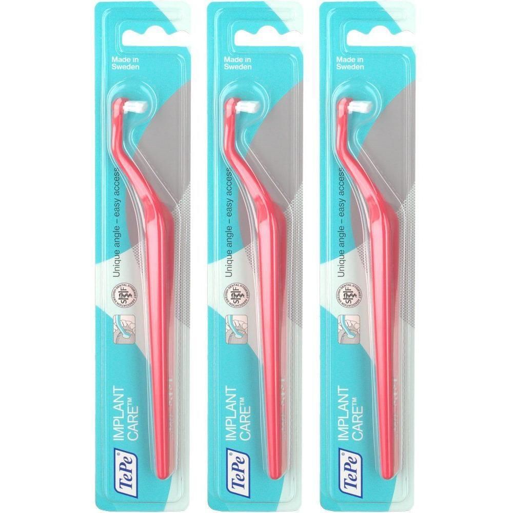 Drie rode TePe® IMPLANT CARE™ tandenborstels met enkele pluim, verpakt in blisterverpakking.