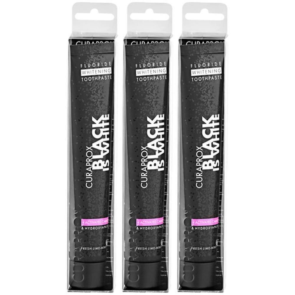 Trois tubes de dentifrice Curaprox Black Is White, emballage noir avec inscription blanche.