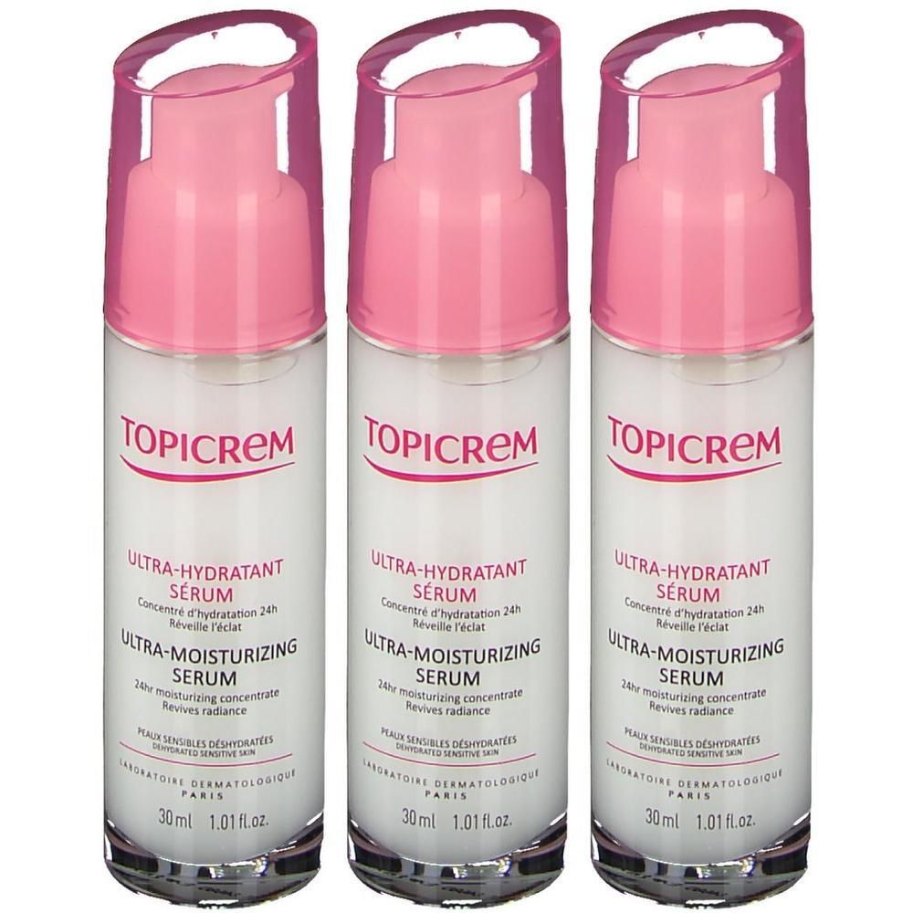 Drie flacons Topicrem ultra-hydraterend serum met roze pompjes.