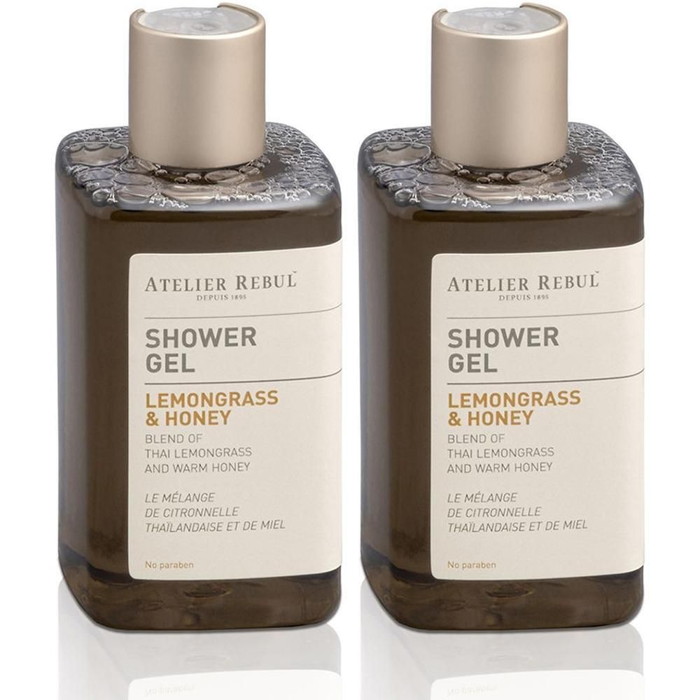Deux flacons de gel douche ATELIER REBUL Citronnelle & Miel avec bouchons dorés.