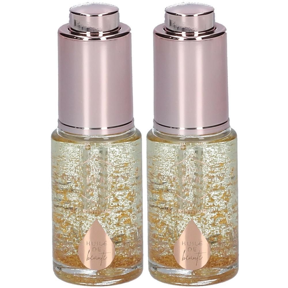 Twee flesjes schoonheidsolie met gouden deeltjes en druppeldop.