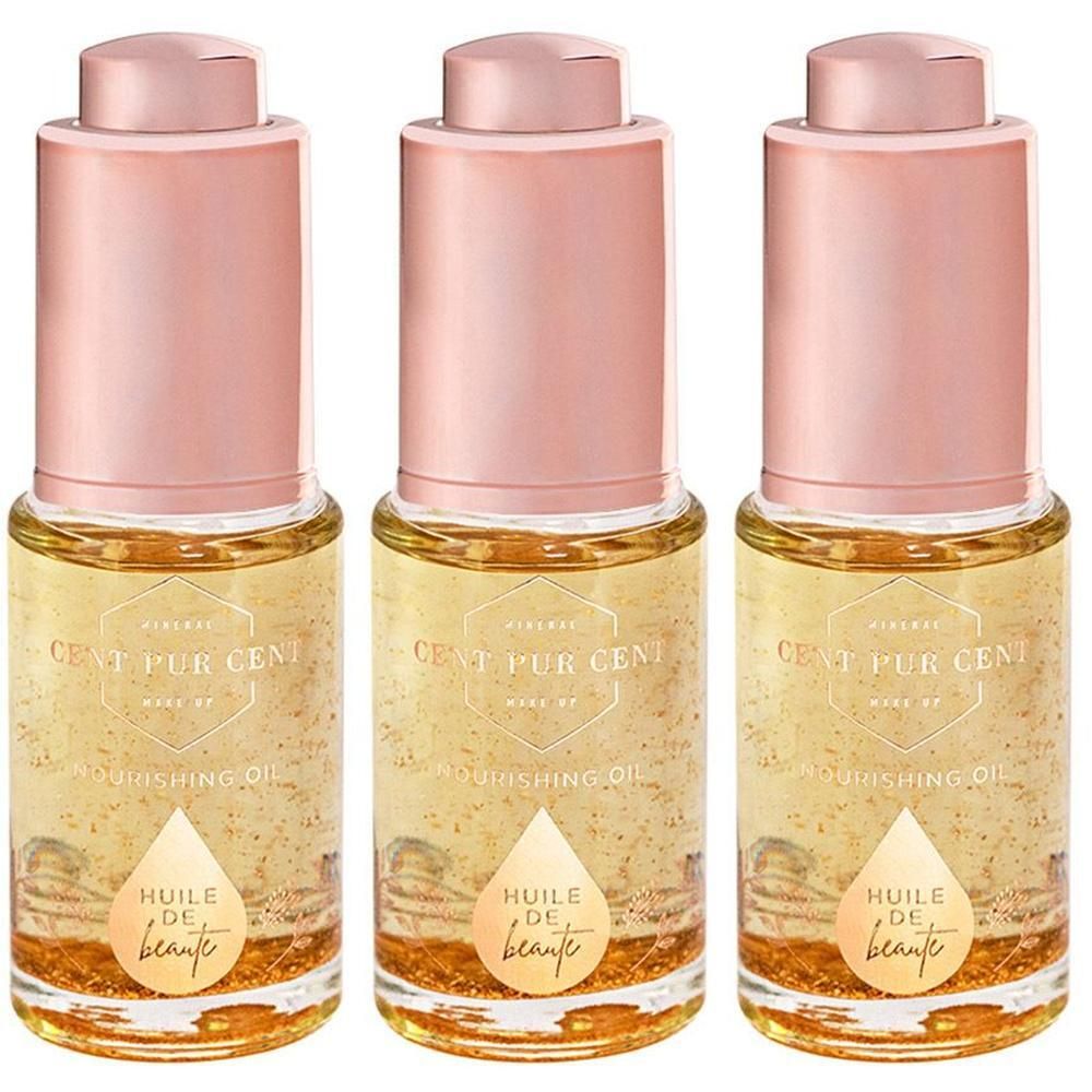 Trois flacons de Cent Pur Cent Huile de Beauté Nourishing Oil avec bouchons rose doré.