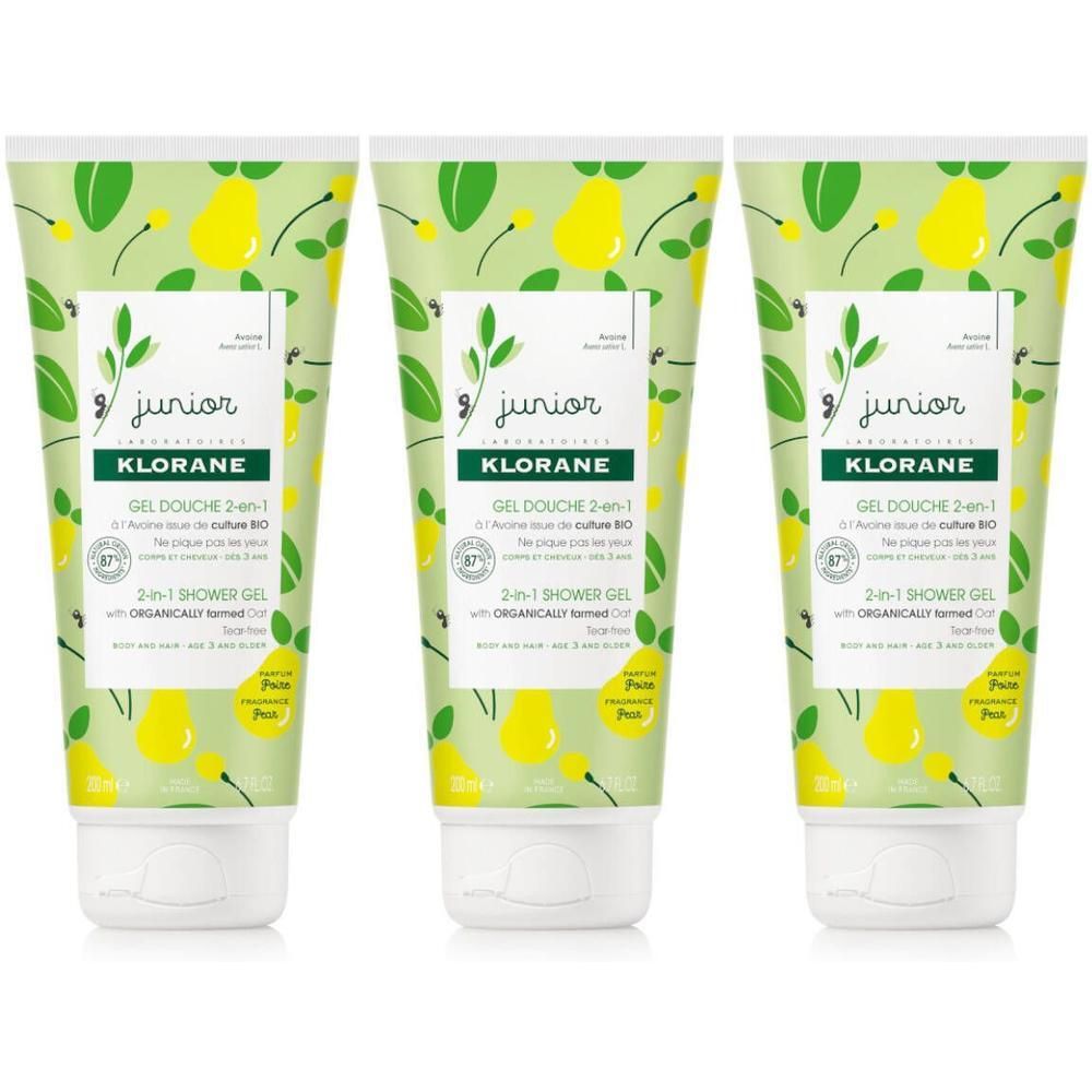 Trois flacons de gel douche Klorane Junior 2-en-1 avec motif poire et inscription 'Junior'.
