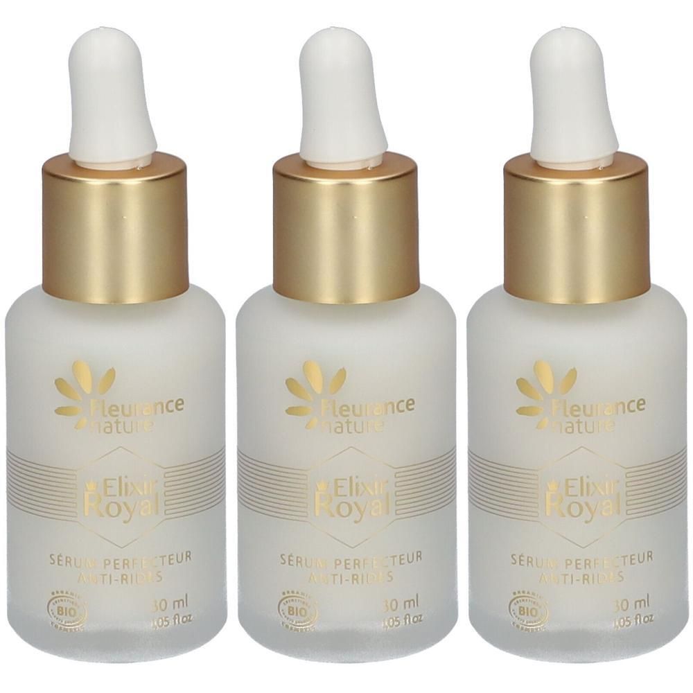 Drie matglazen flesjes met gouden en witte druppelflesdop. Logo en tekst 'Elixir Royal Sérum perfecteur anti-rides'.
