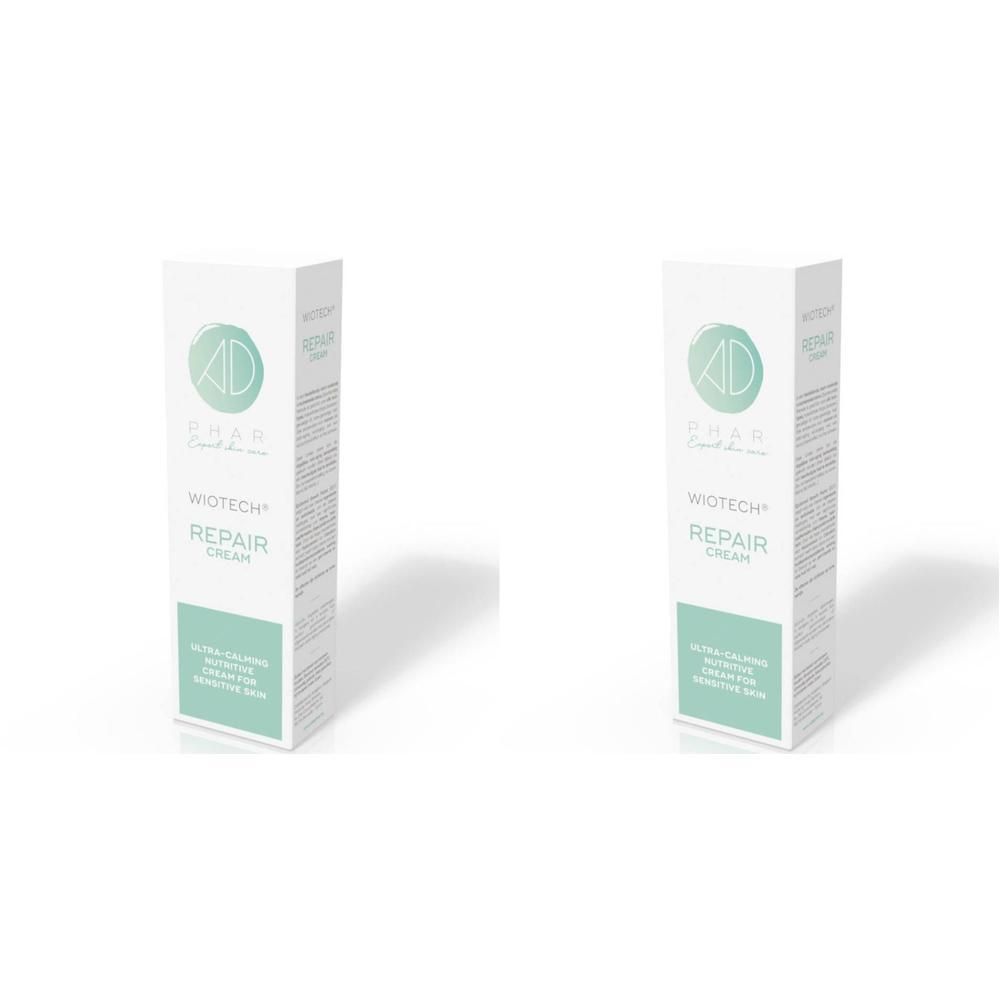 Twee dozen Wiotech Repair Creme, wit met groene accenten. Tekst: Wiotech Repair Cream.