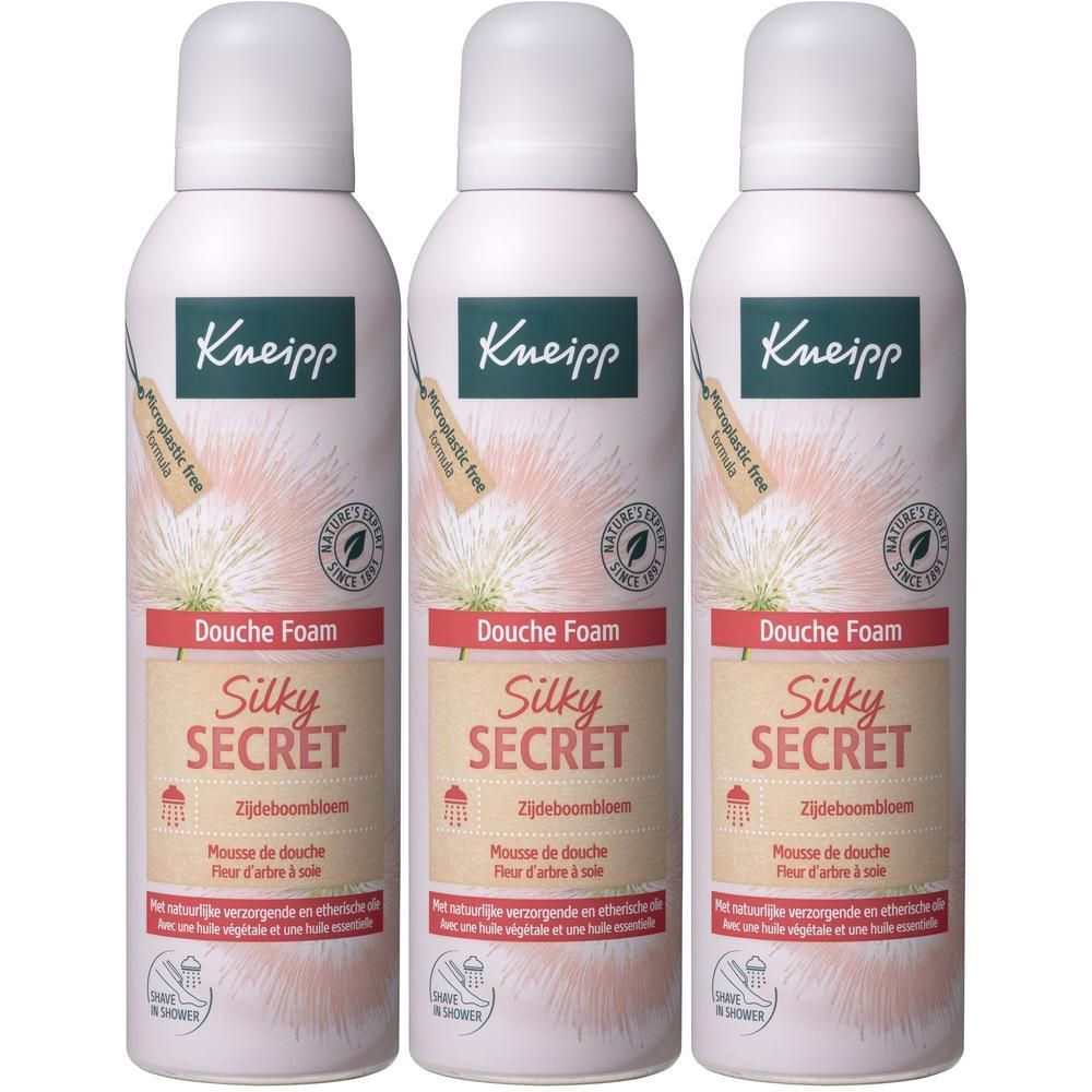 Drie flacons Kneipp Douche Mousse Silky Secret met etiketten en botanische afbeeldingen.