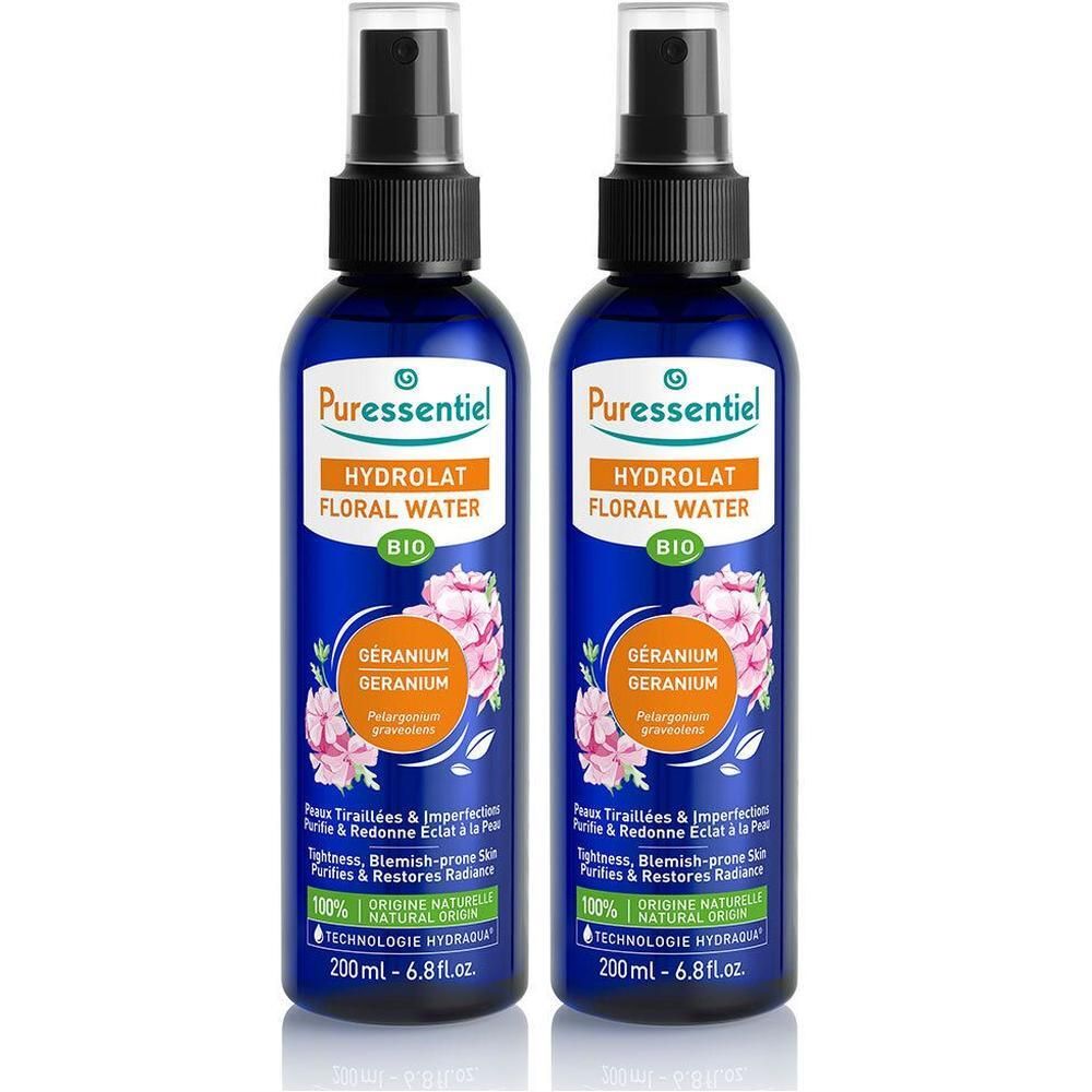 Deux flacons Puressentiel Hydrolat de Géranium Bio avec vaporisateur. Flacons bleus avec étiquette montrant des fleurs et des informations produit.