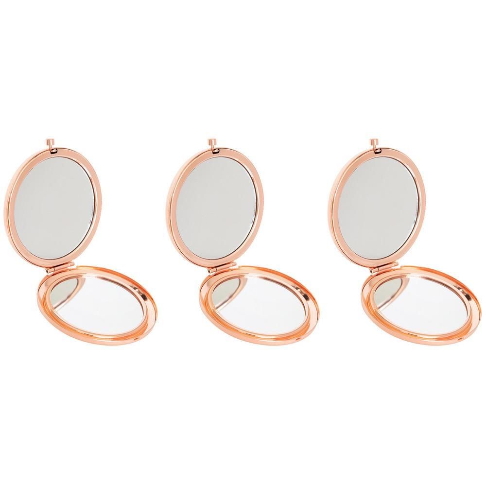 Trois miroirs à main ouverts, couleur or rose, côte à côte.