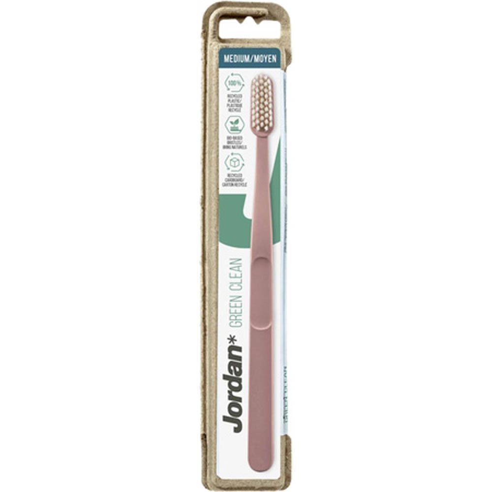 Een Jordan Green Clean Medium tandenborstel in roze, in individuele verpakking.