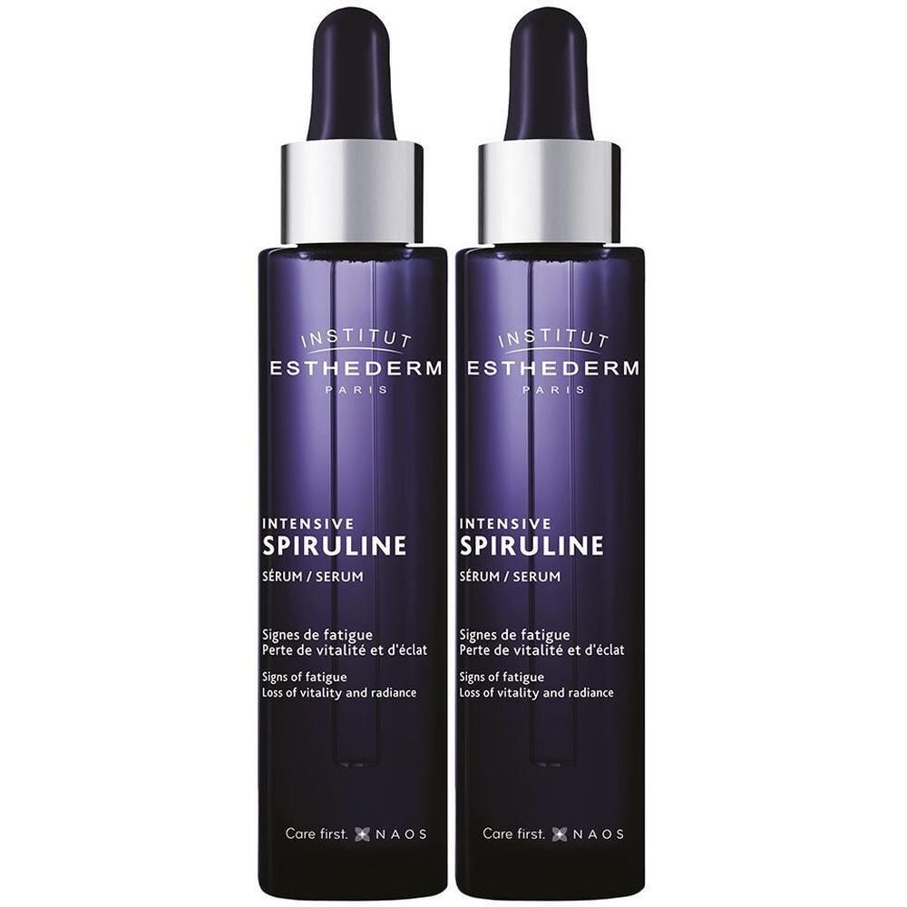 Deux flacons d'Institut Esthederm Intensive Spiruline Sérum avec pipettes. Flacons violet foncé avec bouchons argentés.