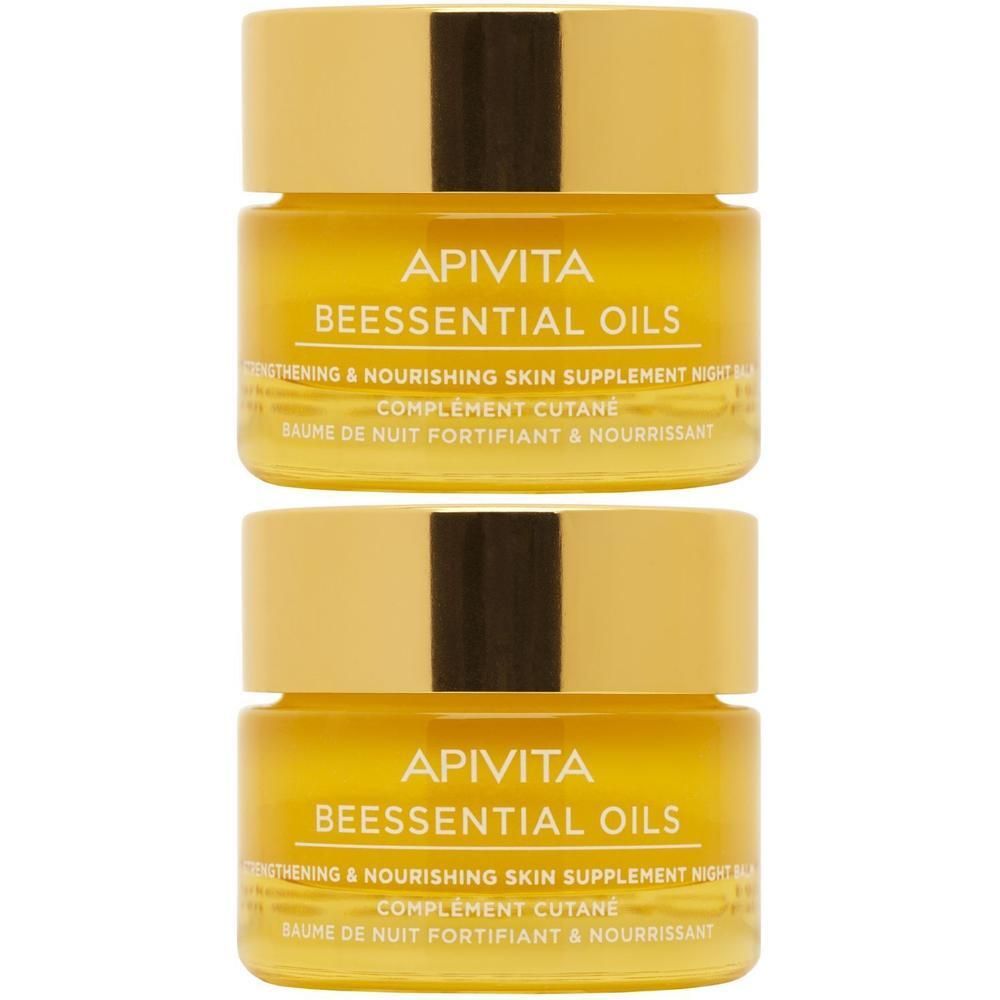 Twee potjes Apivita Beessential Oils Nachtbalsem met gouden dopjes.