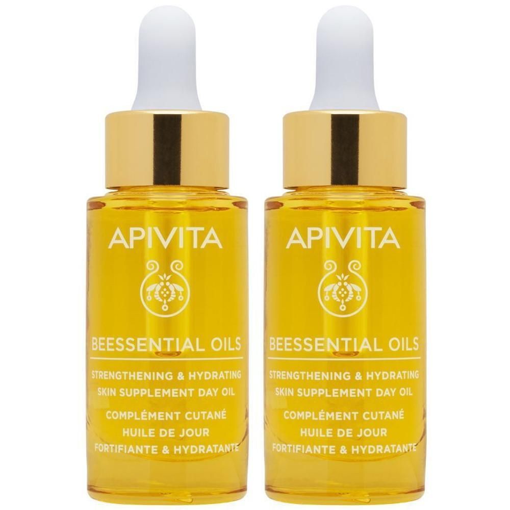 Deux flacons Apivita Beessential Oils avec compte-gouttes, col doré et huile jaune.