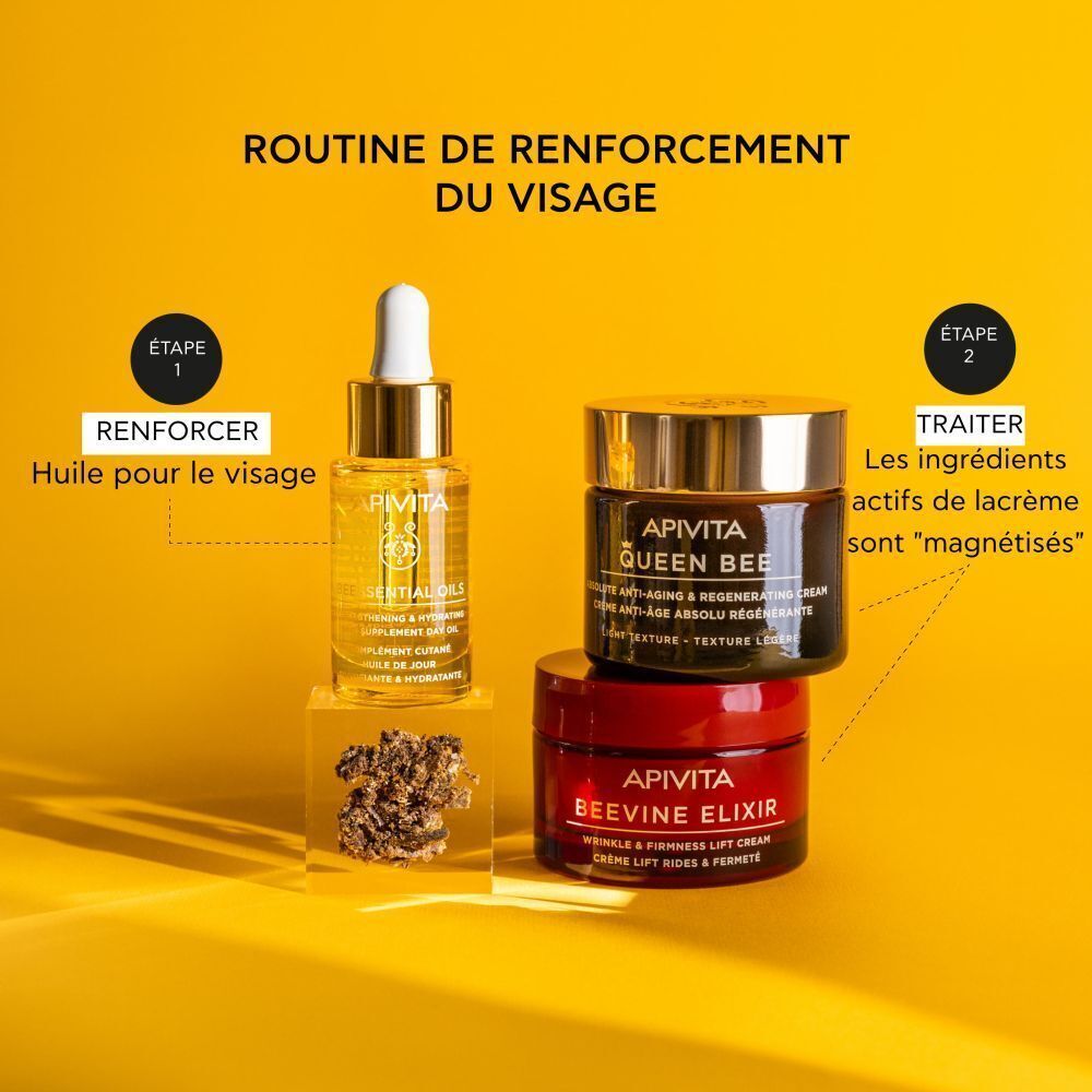 Flacon Apivita Beessential Oils et deux pots de crème dans une présentation de routine de soins de la peau.