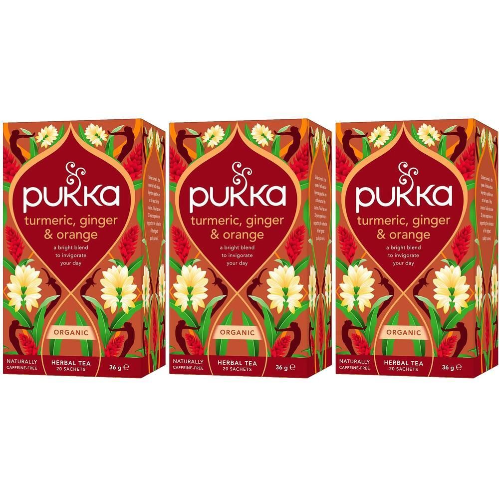 Drie pakken Pukka Thee Kurkuma, Gember & Sinaasappel met bloemenmotief.