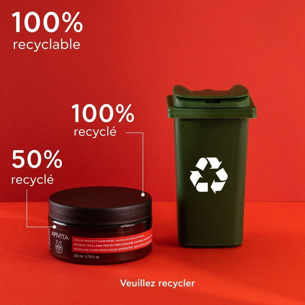 Masque Capillaire Apivita à côté d'une poubelle de recyclage verte, 100% recyclable.