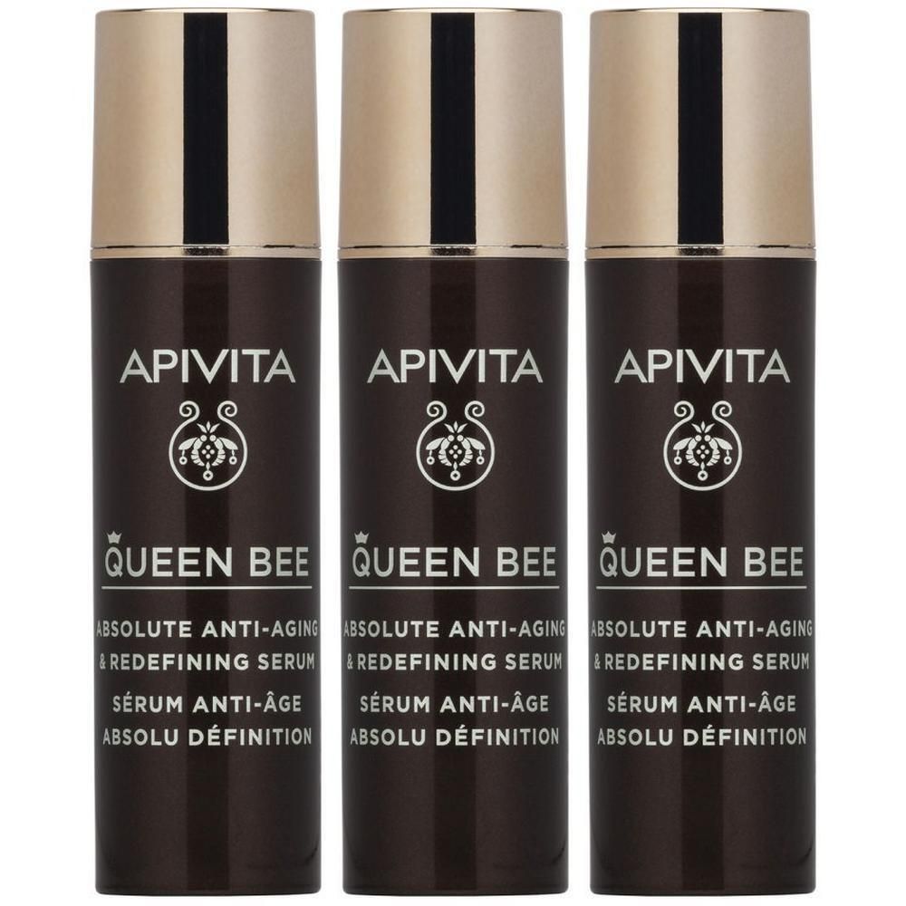 Drie flacons Apivita Queen Bee serum met gouden dopjes.
