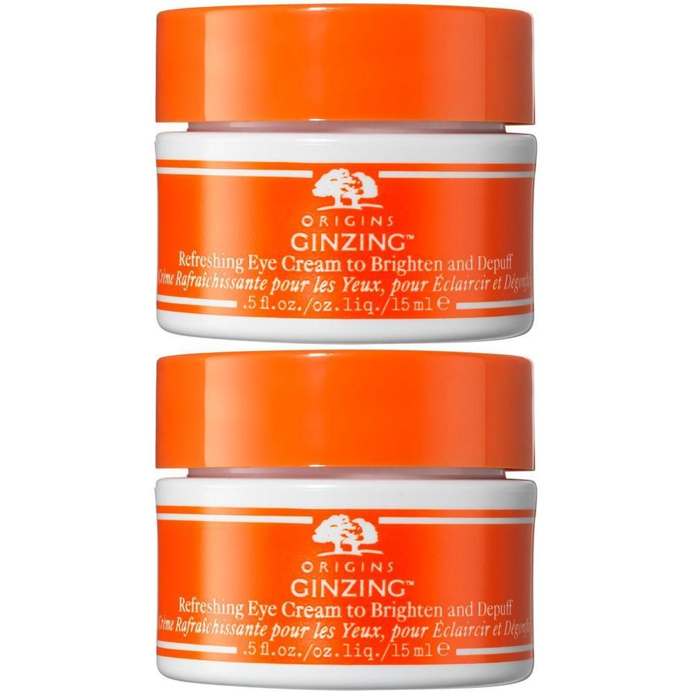 Twee Origins GinZing oogcrème potjes met oranje deksels.
