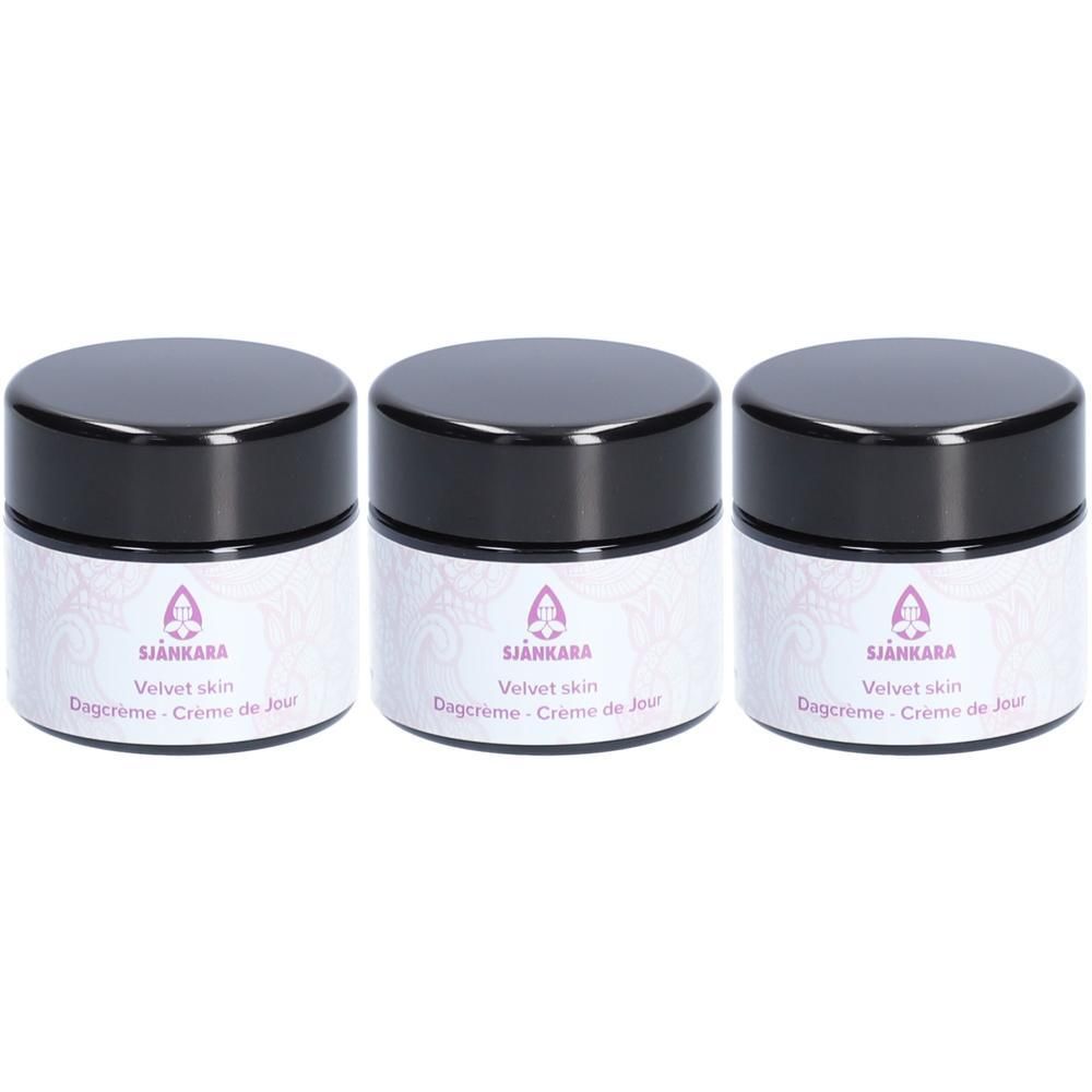 Drie Sjankara Velvet Skin Dagcrème potjes met zwarte deksels en witte etiketten.