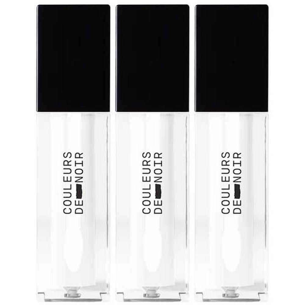 Drie flacons Couleurs de Noir Instant Gloss Lip Oil met zwarte doppen.