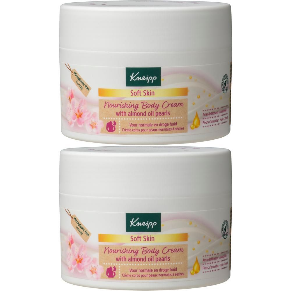 Deux pots blancs de Crème Corps Nourrissante Kneipp aux perles d'huile d'amande.