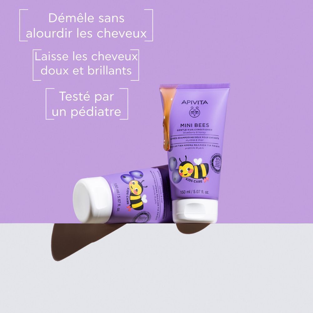 Deux tubes violets Apivita Mini Bees, l'un couché, l'autre debout. Texte : 'Démêle, adoucit et fait briller. Testé par un pédiatre.'