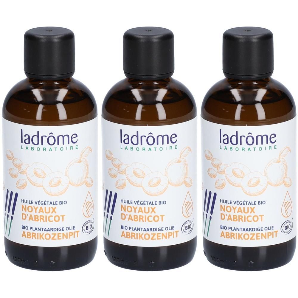 Drie flessen Ladrôme biologische abrikozenpitolie met zwarte dop.
