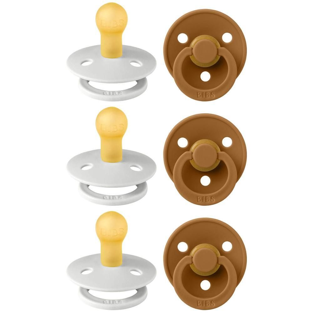 Deux tétines BIBS, une blanche et une marron, avec tétines jaunes.