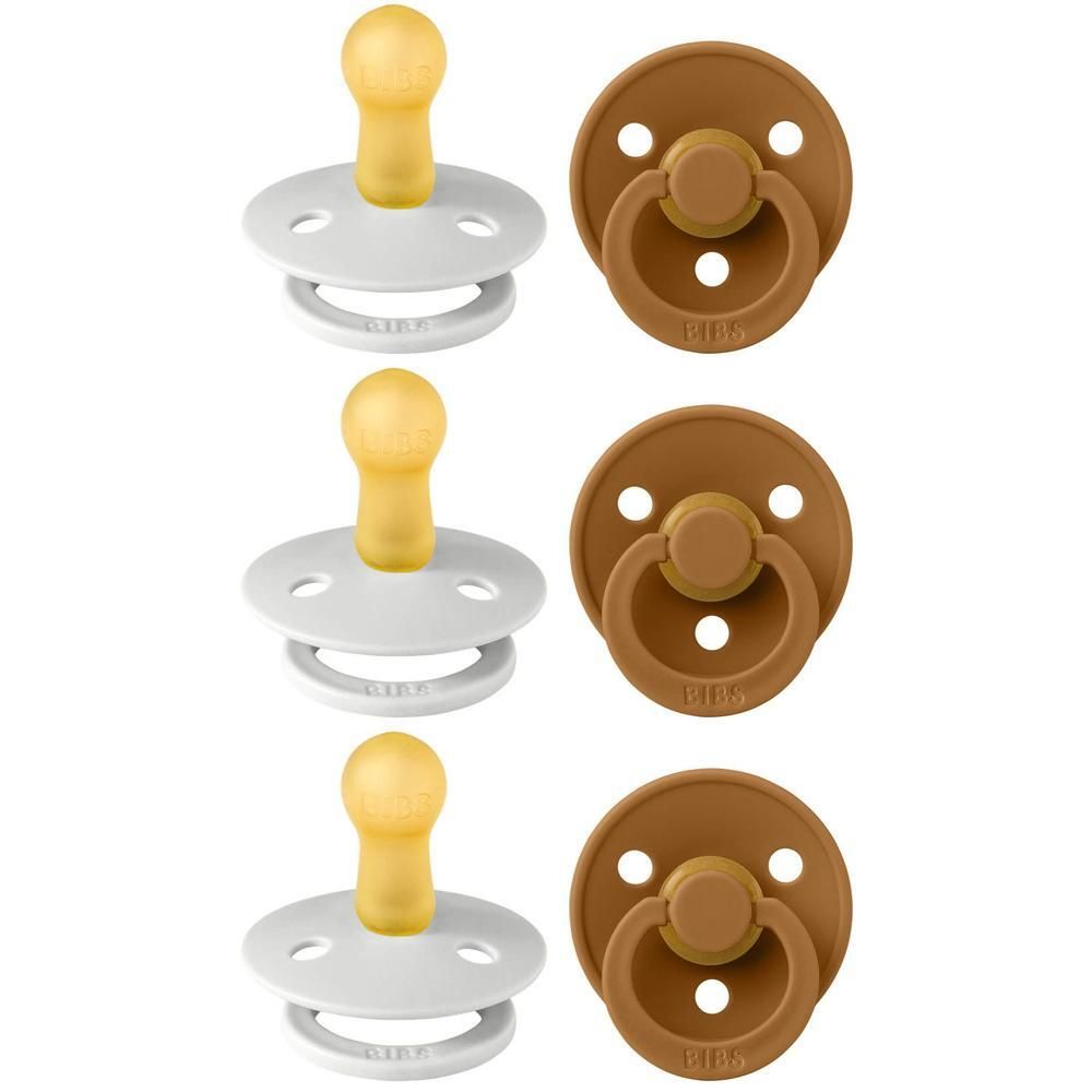 Deux sucettes BIBS : une blanche à tétine jaune, une marron à tétine marron.
