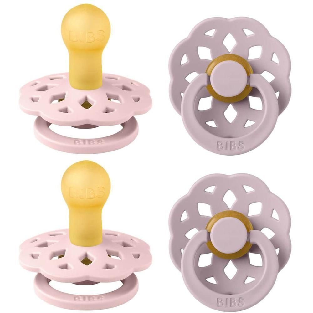 Deux tétines BIBS roses avec tétine jaune et bouclier en forme de pétale.