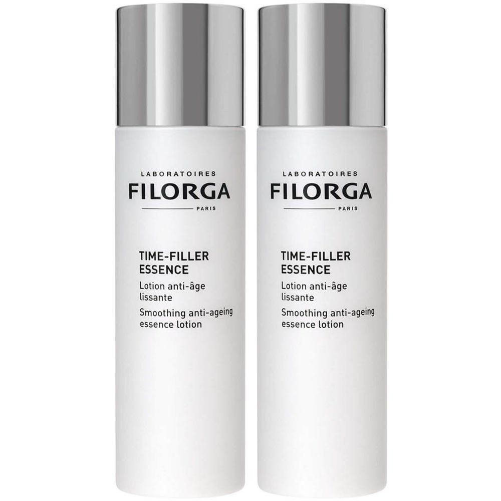 Twee witte flacons Filorga TIME-FILLER ESSENCE lotion met zilveren dopjes.