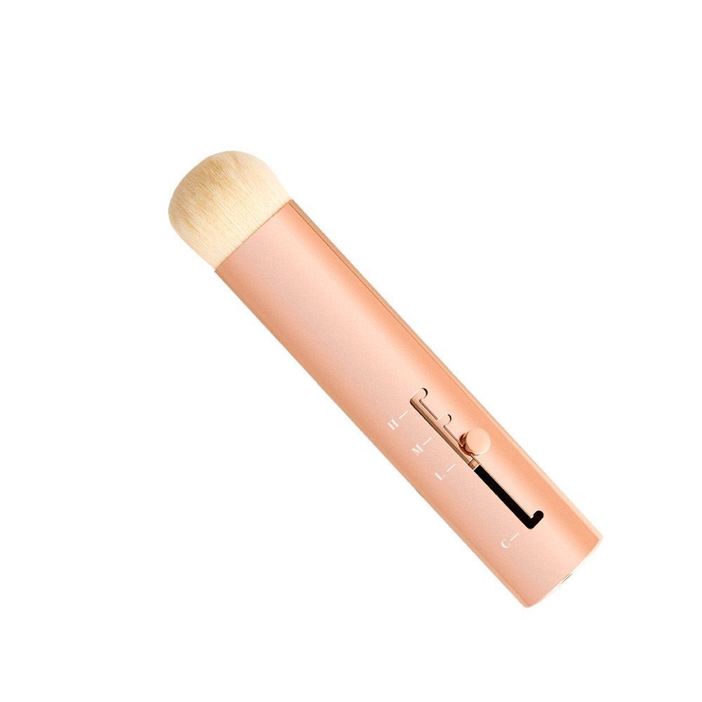 Une brosse rétractable avec manche rose doré et curseur réglable.