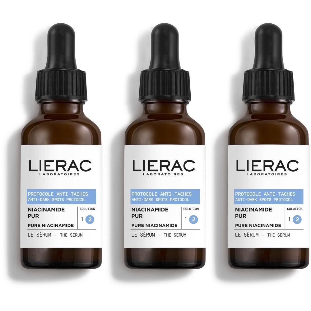 Drie bruine glazen flesjes met druppelaar, Lierac Anti-Taches serum.
