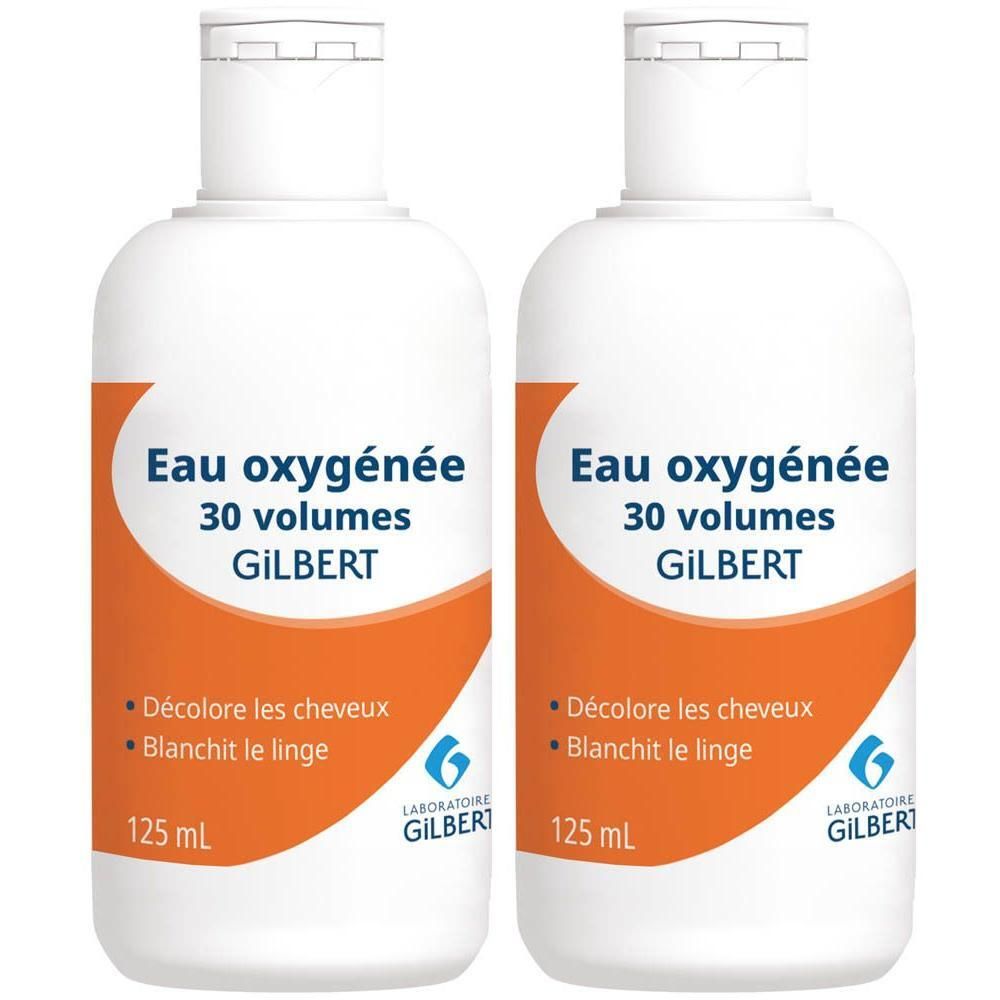 Deux flacons blancs Gilbert Eau Oxygénée 30 volumes, 125 ml. Étiquette orange avec texte noir.