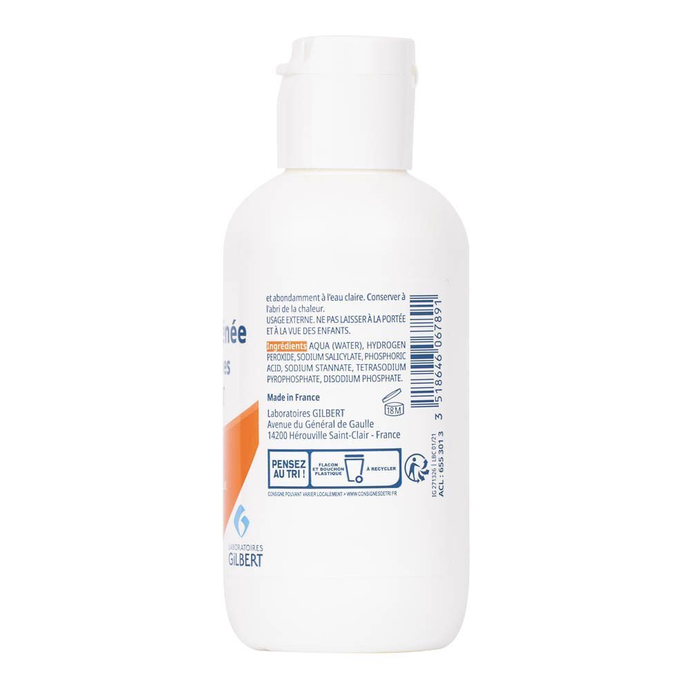 Achterkant van een witte fles Gilbert Eau Oxygénée 30 volumes, 125 ml. Bevat ingrediënten en productielocatie.
