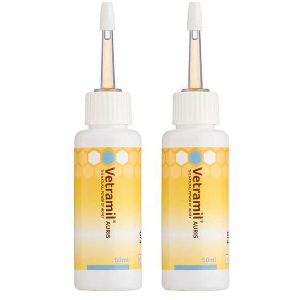 Twee Vetramil Auris flesjes met druppelapplicator. Gele verpakking met honingraatpatroon.