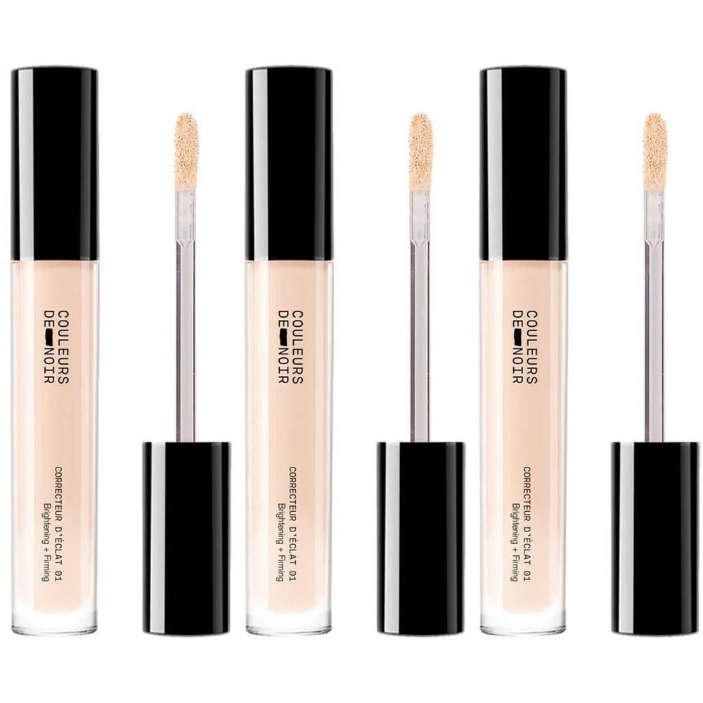 Drie flacons concealer met zwarte dop en applicator. De flacon toont 'COULEURS DE NOIR CORRECTEUR D'ÉCLAT 01 Clair'.