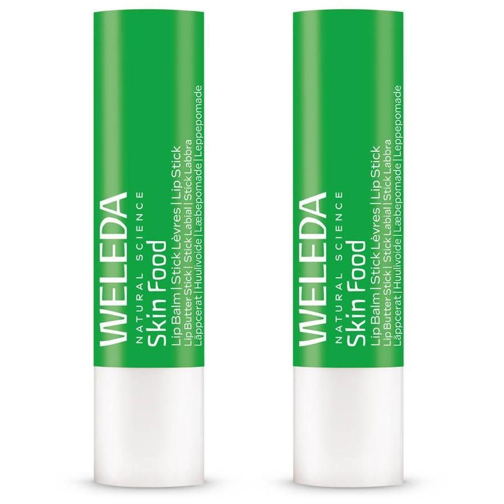 Twee Weleda Skin Food lippenbalsemstiften, groene verpakking, witte basis.