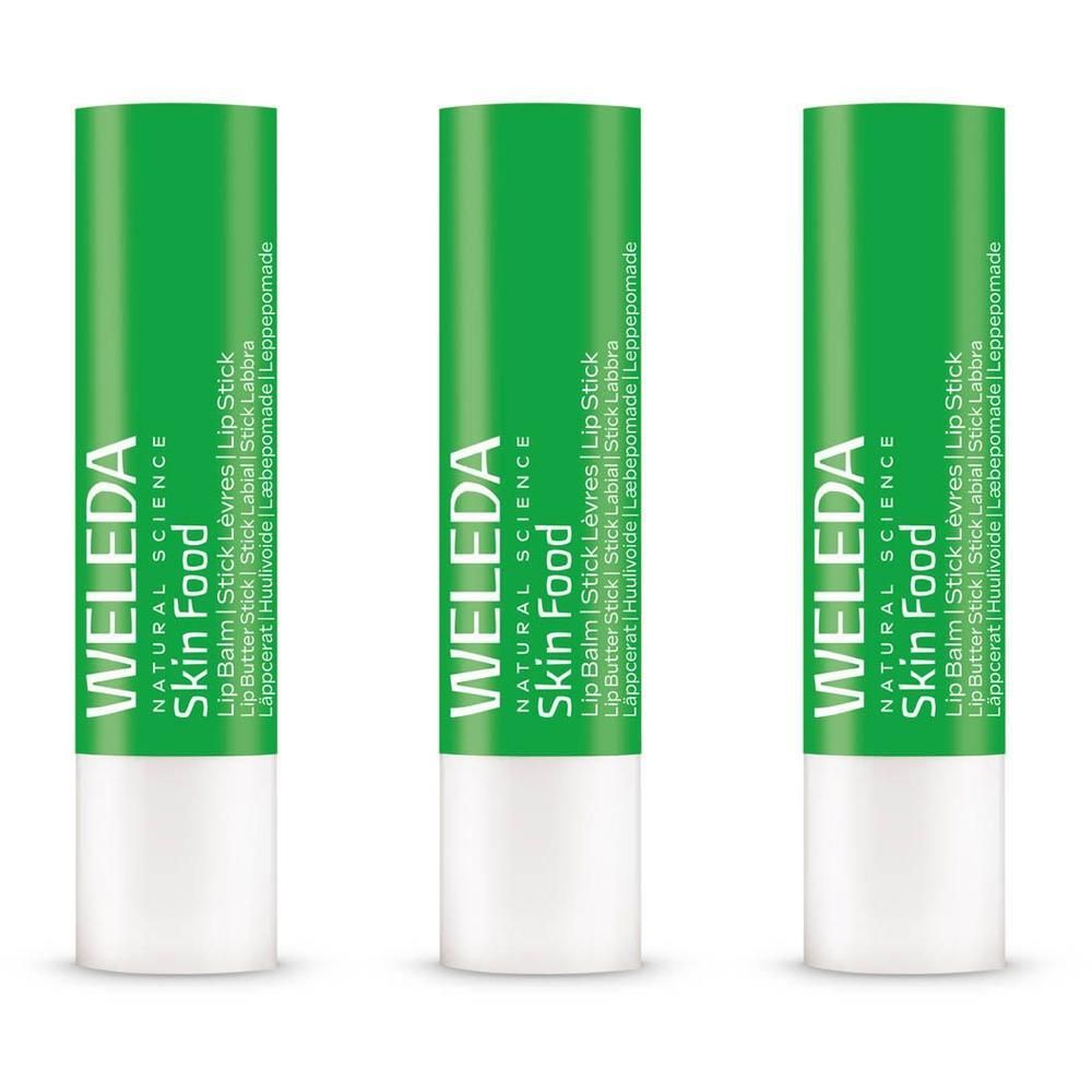 Drie Weleda Skin Food lippenbalsemstiften met groene doppen en witte onderkanten.