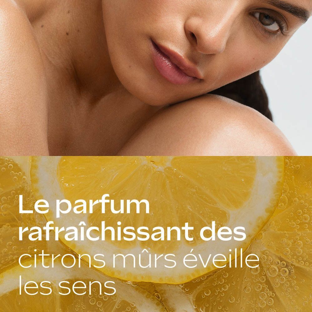 Gros plan de tranches de citron et de bulles, symbolisant le parfum de la lotion Weleda.