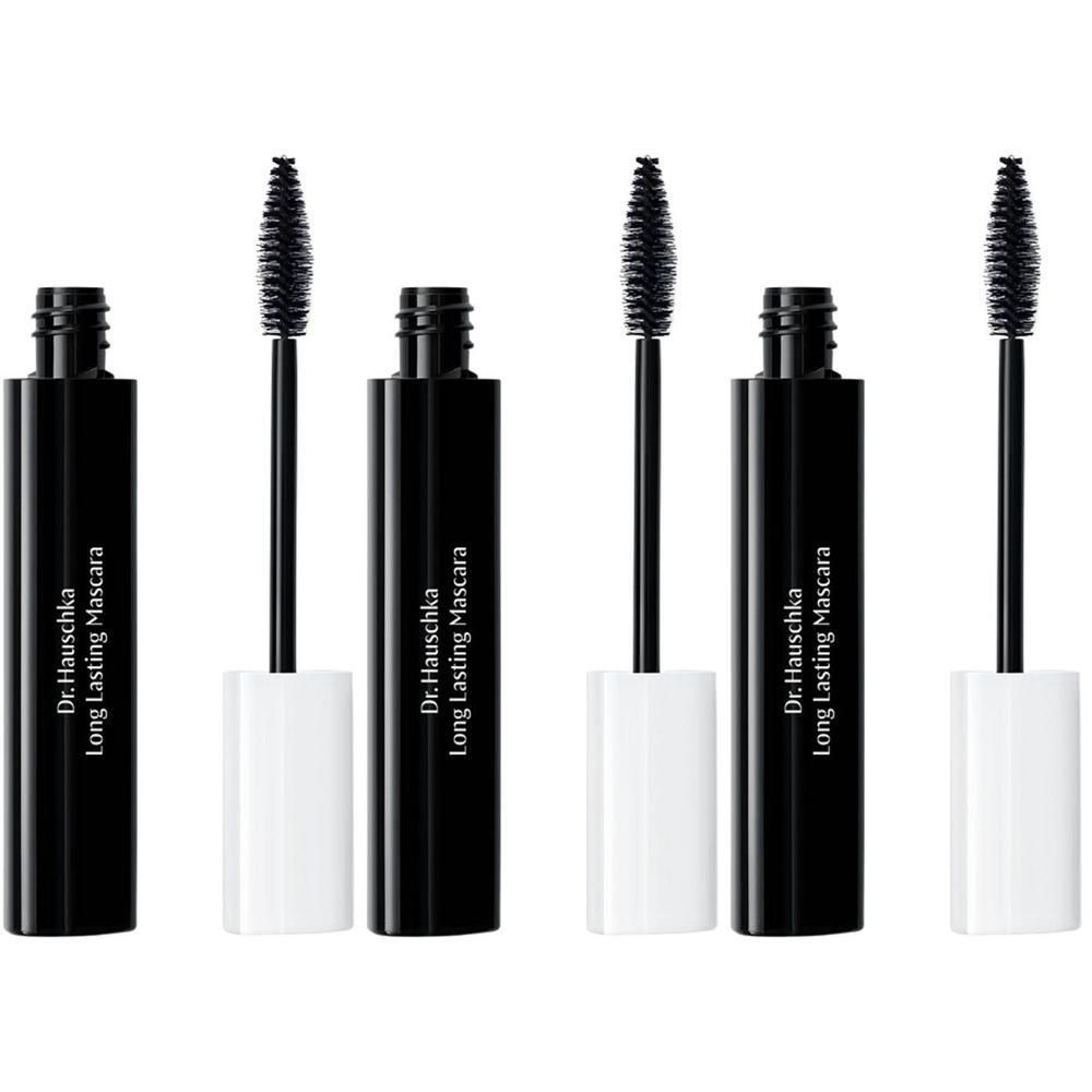 Trois flacons de mascara noirs avec capuchons et brosses blancs. Dr. Hauschka Long Lasting Mascara.