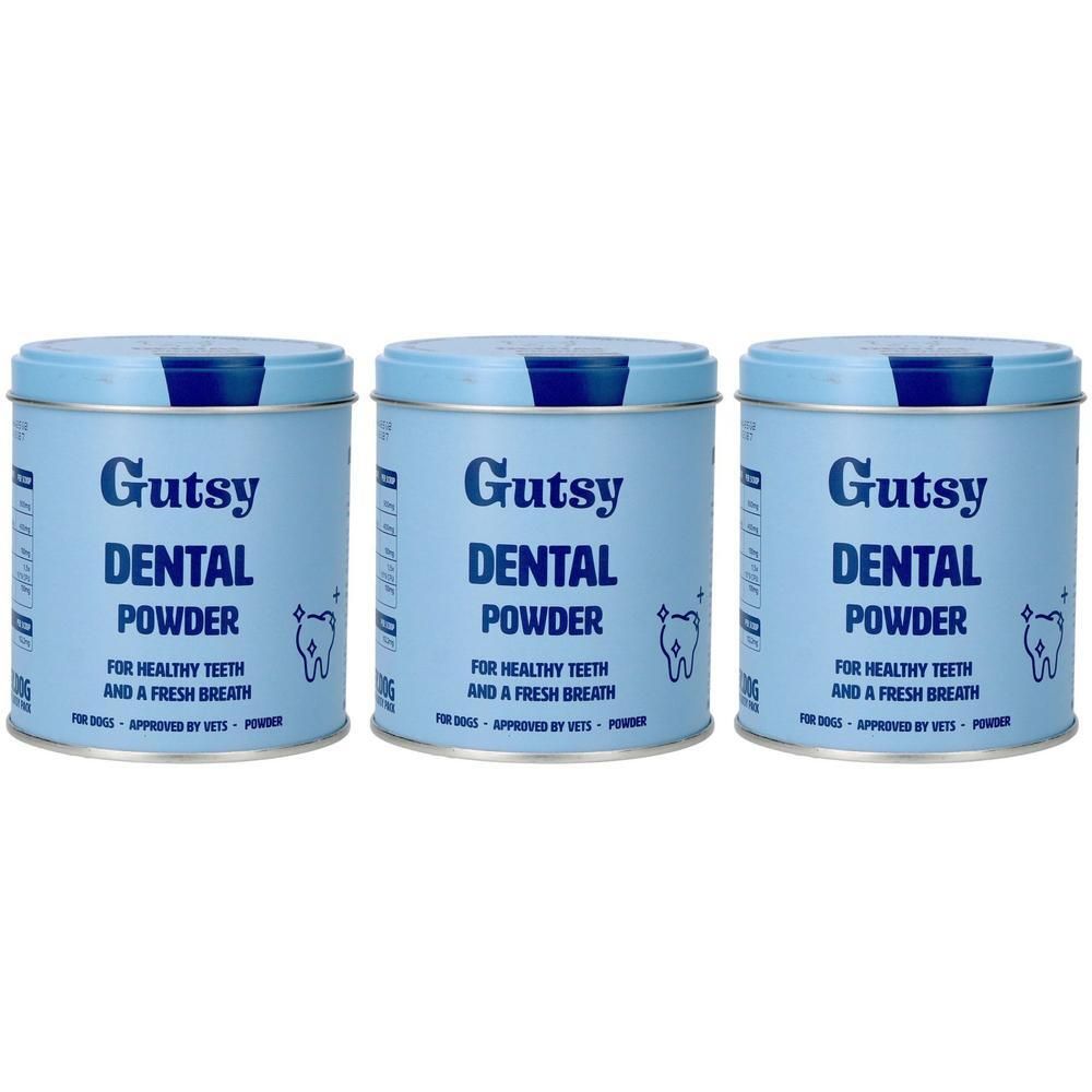 Trois boîtes bleues claires de Gutsy Dental Powder avec inscription blanche et symboles de dents.