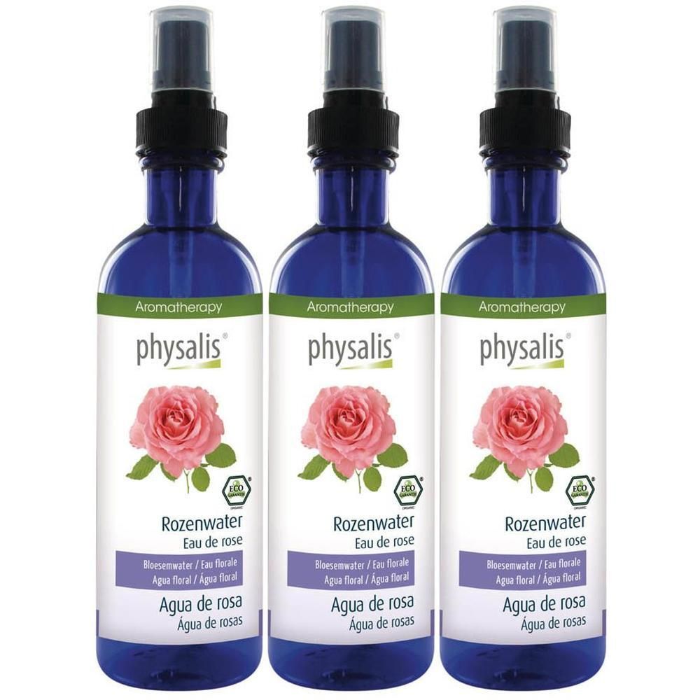 Trois flacons d'eau de rose Physalis avec spray. Flacons en verre bleu avec étiquette montrant une rose rose.