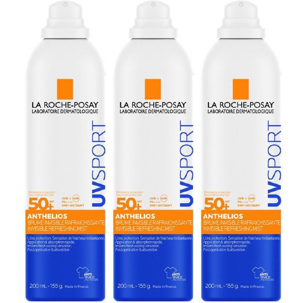 Drie witte spuitbussen La Roche-Posay Anthelios UV Sport zonnebrandcrème.