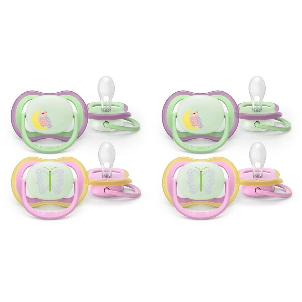 Deux sucettes Philips Avent, une verte/violette, une jaune/rose, avec motif phosphorescent.
