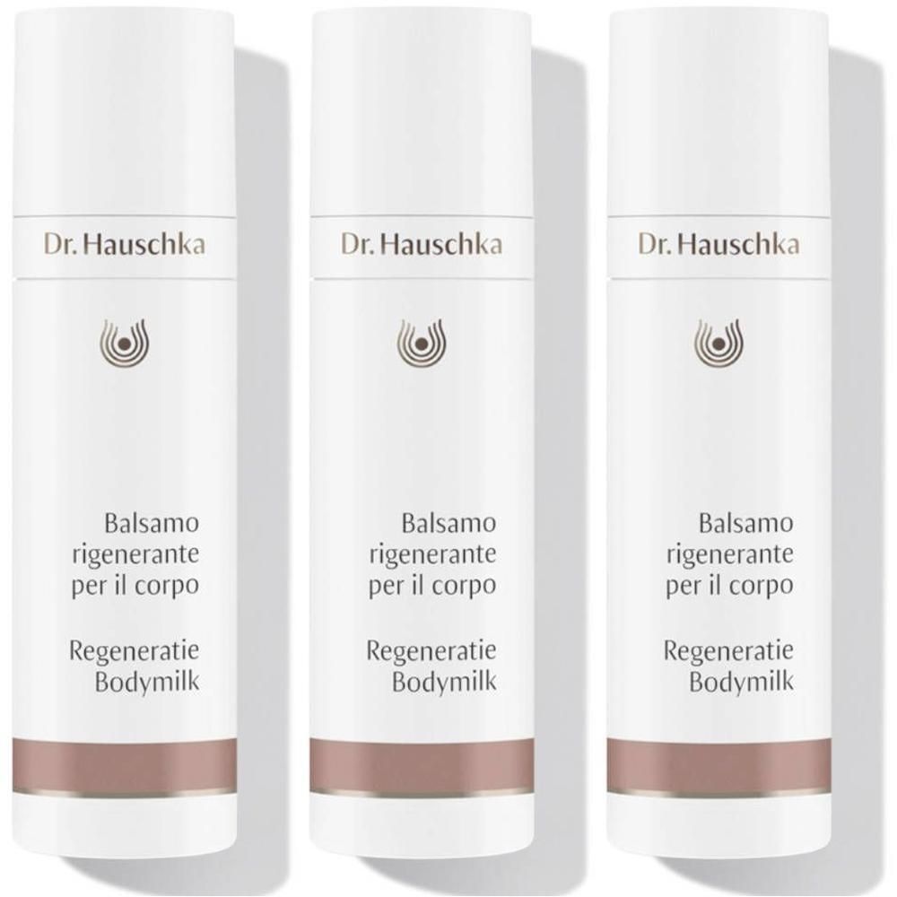 Drie flessen Dr. Hauschka Regeneratie Bodymilk met wit etiket en bruine band.