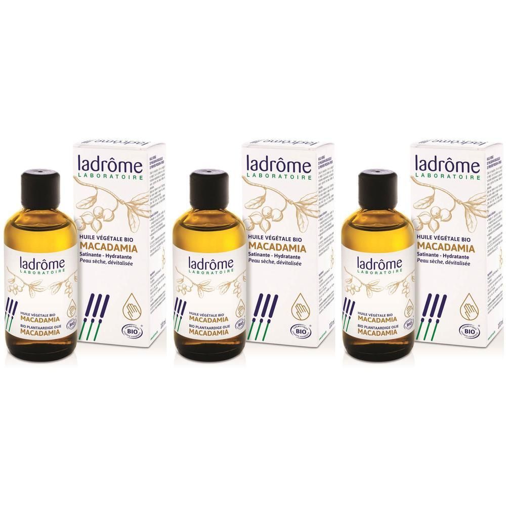 Trois flacons d'huile végétale de macadamia bio Ladrôme avec boîtes. Liquide clair dans des flacons en verre brun.