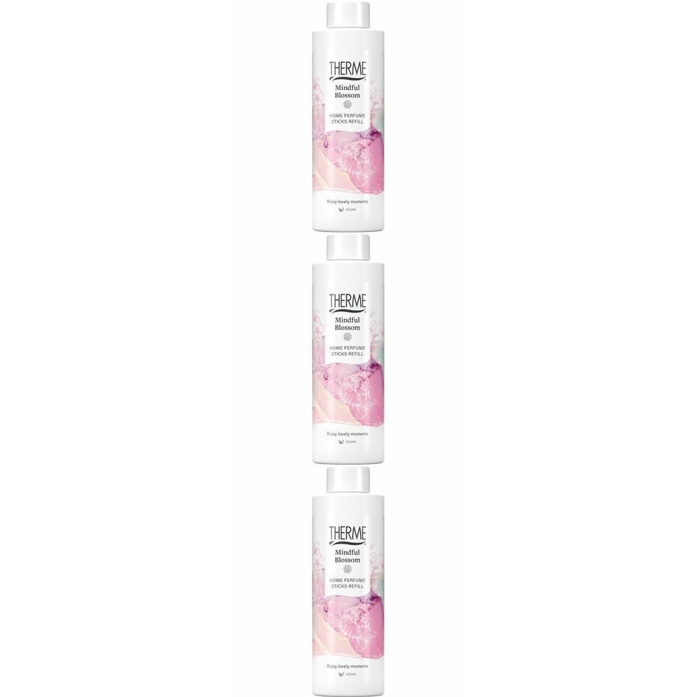 Drie witte flessen met geurstokjes, etiket "Therme Mindful Blossom".