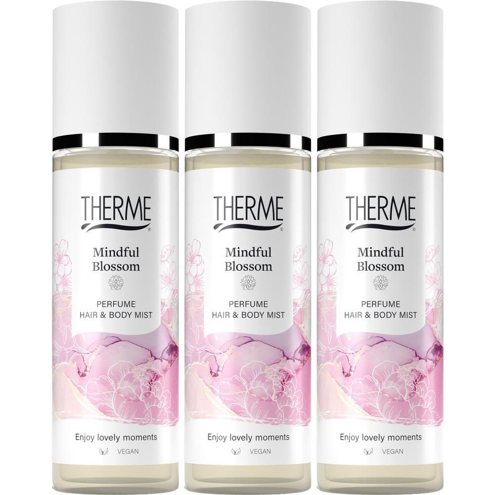 Trois flacons de brume parfumée pour cheveux et corps Therme Mindful Blossom, bouchon blanc, motif floral rose.