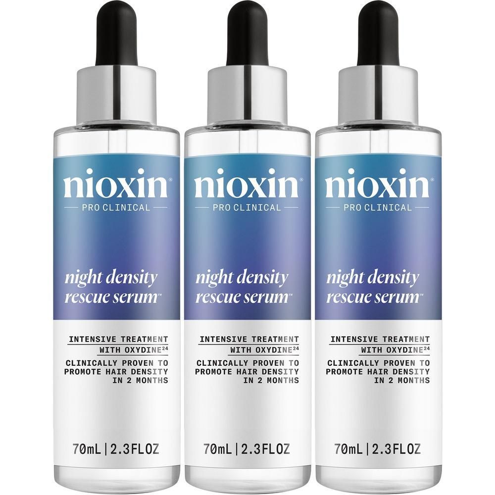 Trois flacons de Nioxin Night Density Rescue Sérum avec compte-gouttes. Chaque flacon contient 70 ml.